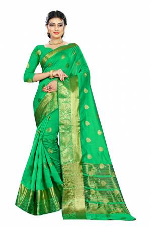 Beat This Heat This Summer Wearing This Pretty Attractive Green Colored Saree. This Saree And Blouse Are Fabricated On Cotton Silk Beautified With Weave Butti All Over. Also It Is Light In Weight And Easy To Carry All Day Long. 