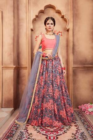 Go Colorful With This Designer Lehenga Choli In Dark Peach Colored Blouse Paired With Grey Colored Lehenga And Dupatta. Its Blouse Is Fabricated On art Silk Paired With Net Fabricated Embroidered Lehenga And Net Dupatta. 