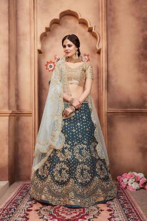 Grab This Very Pretty Heavy Designer Lehenga Choli In Golden Colored Blouse Paired With Teal Blue Colored Lehenga And Aqua Blue Colored Dupatta. Its Blouse Are Lehenga Are Fabricated On Art Silk Paired With Net Fabricated Dupatta. 