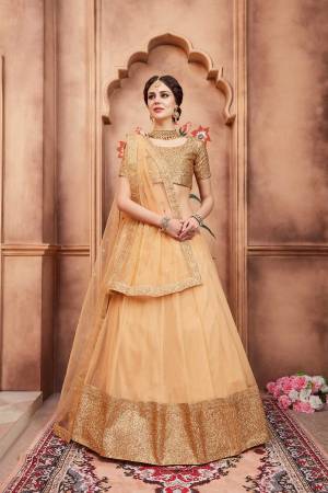 Celebrate This Festive Season Wearing This Designer Lehenga Choli In Beige Color. Its Heavy Embroidered Blouse Is Paired With Net Fabricated Lehenga And Dupatta. It Is Beautified With Attractive Sequence Embroidery. 