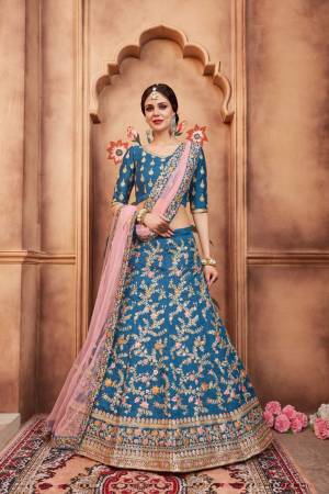 Add This Lovely Designer Lehenga Choli To Your Wardrobe In Blue Color Paired With Pretty Pink Colored Dupatta. This Lehenga Choli Is Silk Based Paired With Net Fabricated Dupatta. Buy This Now. 