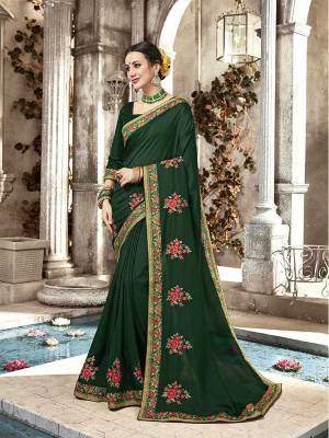 Here Is A Beautiful Designer Saree In Dark Green Color Paired With Dark Green Colored Blouse. This Saree And Blouse Are Silk Beautified With Contrasting Embroidery Giving It An Attractive Look. 