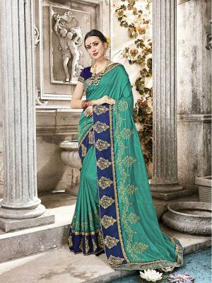Celebrate This Festive Season Wearing This Designer Saree In Sea Green Color Paired With Contrasting Royal Blue Colored Blouse. It Is Rich Silk Based Which Earn You Lots Of Compliments From Onlookers. 
