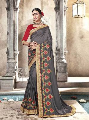 Flaunt Your Rich And Elegant Taste Wearing This Designer Saree In Grey Color Paired With Contrasting Red Colored Blouse. Its Lovely Color Pallete And Rich Silk Fabric Will Give Youe Personality An Enhanced Look .