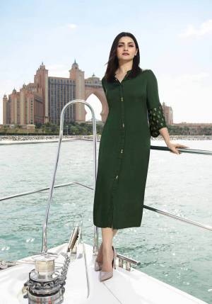 Simple And Elegant Patterned Readymade Kurti Is Here In Dark Green Color Fabricated On Satin Silk Beautified With Embroidered Butti Over The Bell Sleeves. Buy Now.