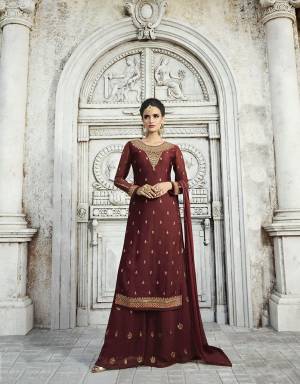 Here Is A Royal Looking Designer Plazzo Suit In Maroon Color. Its Top Is Fabricated On Satin Georgette Paired With Georgette Bottom And Chiffon Fabricated Dupatta. Its Top And Bottom Are Beautified With Attractive Embroidery. Buy Now.