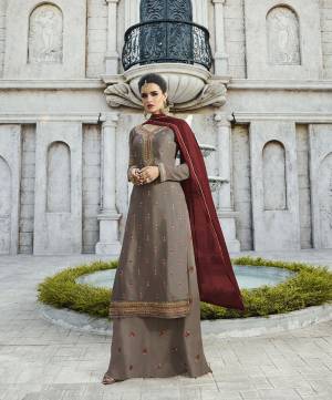 New Shade Is Here To Add Into Your Wardrobe With This Designer Straight Plazzo Suit In Sand Grey Colored Top And Bottom Paired With Contrasting Maroon Colored Dupatta. Its Top IS Fabricated On Satin Georgette Paired With Georgette Bottom And Chiffon Fabricated Dupatta, All Its Fabrics Are Light Weight And Easy To Carry All Day Long.