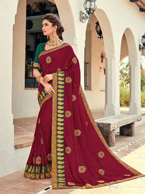 Wear this Maroon color silk pattern saree. Ideal for party, festive & social gatherings. this gorgeous saree featuring a beautiful mix of designs. Its attractive color and designer heavy embroidered design, Flower embroidered butta design, stone design, beautiful floral design work over the attire & contrast hemline adds to the look. Comes along with a contrast unstitched blouse.