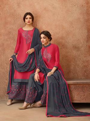 Celebrate This Festive Season With Ease, Comfort And Beauty By Getting This Dress Material Stitched As Per Your Desired Fit And Comfort. Its Top Is In Dark Pink Color Paired With Contrasting Dark Grey Colored Bottom And Dupatta. This Dress Material Is Fabricated On Cotton Paired With Chiffon Dupatta. 