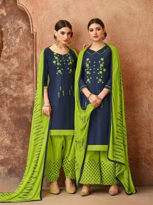 Add This Pretty Dress Material In Navy Blue And Parrot Green Color For Your Casual Wear, This Dress Material Is Cotton based Paired With Chiffon Fabricated Dupatta. Get This Stitched As Per Your Desired Fit And Comfort. Buy Now.