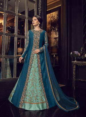 Add This Elegant And New Patterned Indo-Western Dress To Your Wardrobe In Shades Of Blue. It Has Very Pretty Aqua Blue Colored Gown With A Blue Colored Jacket Paired With Aqua Blue Colored Embroidered Pants And Blue Dupatta. Its Heavy Embroidered Gown Is Net Based Paired With Art Silk Jacket , Art Silk Pant And Net Fabricated Dupatta. 