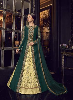 Add This Elegant And New Patterned Indo-Western Dress To Your Wardrobe In Shades Of Green. It Has Very Pretty Light Yellow Colored Gown With A Pine Green Colored Jacket Paired With Light Yellow Colored Embroidered Pants And Pine Green Dupatta. Its Heavy Embroidered Gown Is Net Based Paired With Art Silk Jacket , Art Silk Pant And Net Fabricated Dupatta. 