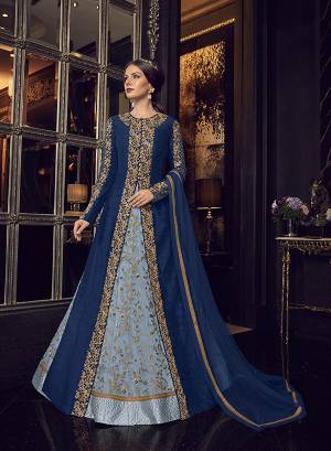 Add This Elegant And New Patterned Indo-Western Dress To Your Wardrobe In Shades Of Blue. It Has Very Pretty Steel Blue Colored Gown With A Royal Blue Colored Jacket Paired With Steel Blue Colored Embroidered Pants And Royal Blue Dupatta. Its Heavy Embroidered Gown Is Net Based Paired With Art Silk Jacket , Art Silk Pant And Net Fabricated Dupatta. 