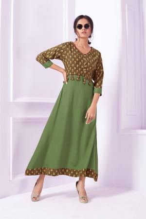 Long Designer Readymade Kurti Is Here In Green Color With Yoke Pattern. It Is Fabricated On Rayon Beautified With Prints.