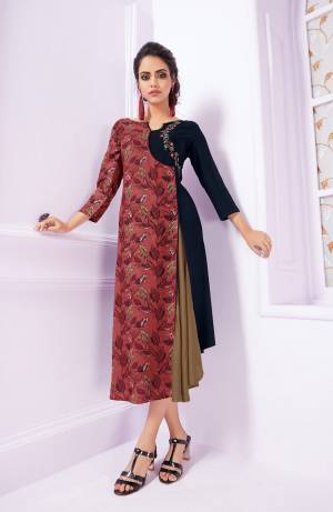 New And Unique Patterned Designer Readymade Kurti Is Here In Pink And Navy Blue Color Fabricated On Rayon. It Is Beautified With Prints Ans Its Fabrics Ensures Superb Comfort all Day Long.  