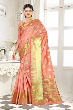 Add This Beautiful Silk Based Saree To Your Wardrobe In Peach Color Paired With Peach Colored Blouse. It Is Beautified With Attractive Butti Weave Over The Saree And Blouse. Buy Now.