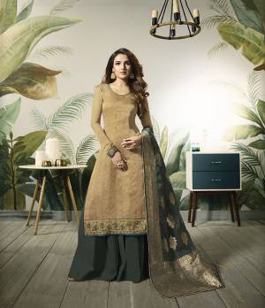 Celebrate This Festive Season Wearing This Designer Straight Suit In Beige Colored Top Paired With Contrasting Dark Green Colored Bottom And Dupatta. Its Top Is Fabricated On Satin Silk Paired With Santoon Bottom And Banarasi Silk Dupatta. 
