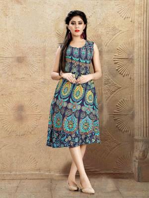 Beat The Heat Wearing This Knee Length Readymade Kurti In Blue Color. This Kurti Is Fabricated On Rayon Beautified With Prints All Over. 