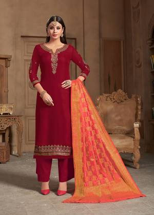 Adorn The Pretty Angelic Look Wearing This Designer Straight Suit In Red Color Paired With Contrasting Dark Peach Colored Dupatta. Its Embroidered Top Is Fabricated On Satin Georgette Paired With Santoon Bottom And Banarasi Silk Fabricated Dupatta. 