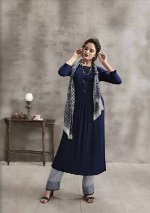Enhance Your Personality In This Rich Color Pallete With This Designer Readymade Kurti Set In Navy Blue Color paired With Grey Colored Plazzo And Scarf. Its Top And Bottom are Rayon Fabricated Paired With Soft Cotton Scarf. It Has Pretty Thread Work Over Plazzo And Printed Scarf. 