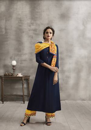 Here Is A Beautiful All Occasion Wear Plazzo Set In Navy Blue Colored Kurti Paired With Yellow Colored Plazzo And Scarf, Its Top And Bottom Are Fabricated On Rayon Paired With Soft Cotton Printed Scarf. It Has Multi Colored Embroidery Over Plazzo And Printed Scarf. 