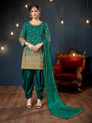 Get Ready For The Upcoming Festive And Wedding Season With This Heavy Designer Suit In Teal Green Color. Its Heavy Embroidered Top Is Fabricated On Tafeta Art Silk Paired With Santoon Bottom And Net Fabricated Dupatta. It Is Beautified With Heavy Jari Embroidery And Mirror Work. 