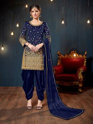 Get Ready For The Upcoming Festive And Wedding Season With This Heavy Designer Suit In Royal Blue Color. Its Heavy Embroidered Top Is Fabricated On Tafeta Art Silk Paired With Santoon Bottom And Net Fabricated Dupatta. It Is Beautified With Heavy Jari Embroidery And Mirror Work. 