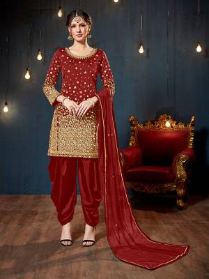 Get Ready For The Upcoming Festive And Wedding Season With This Heavy Designer Suit In Red Color. Its Heavy Embroidered Top Is Fabricated On Tafeta Art Silk Paired With Santoon Bottom And Net Fabricated Dupatta. It Is Beautified With Heavy Jari Embroidery And Mirror Work. 