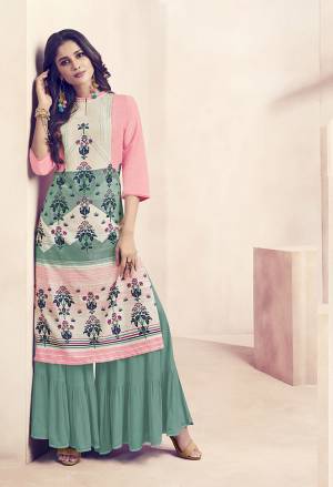 Grab This Very Pretty Readymade Plazzo Set For Your Casuals Or Semi-Casuals. Its Top Is In Pink And Green Color Paired With Green Colored Bottom. It Is Fabricated On Rayon Beautified With Prints And Available In all Regular Sizes. 