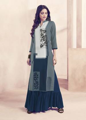 Be It Your Home, Casual Outing Or Work Place, This Readymade Kurti And Plazzo Set Is Suitable For All. Its Top Is In Grey And Navy Blue Color Paired With Navy Blue Colored Bottom. Its Top And Bottom Are Fabricated On Rayon Beautified With Prints. 