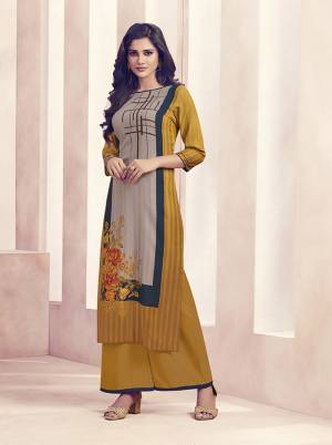 Grab This Very Pretty Readymade Plazzo Set For Your Casuals Or Semi-Casuals. Its Top Is In Musturd Yellow And Grey Color Paired With Musturd Yellow Colored Bottom. It Is Fabricated On Rayon Beautified With Prints And Available In all Regular Sizes. 