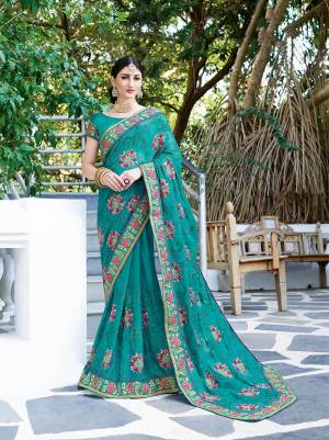 Celebrate This Festive Season Wearing This Designer Silk Based Saree In Turqoise Blue Color Paired With Turquoise Blue Colored Blouse. This Saree Is Georgette Based Beautified With Thread Embroidery And Stone Work