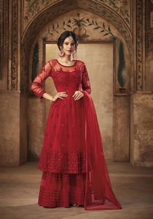 Adorn The Pretty Angelic Look Wearing This Designer Heavy Sharara Suit In Red Color. This Whole Sharara Suit In Net Based Beautified With Pretty Tone Tone To Embroidery. Buy Now.