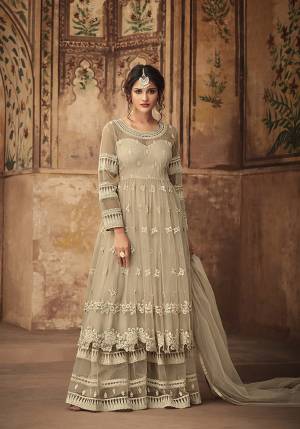 Simple And Elegant Looking Designer Heavy Sharara Suit In Off-White Color. This Sharara Suit Is Fabricated On Net Beautified With Heavy Tone To Tone Embroidery And Stone Work. 