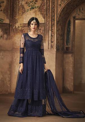 Get Ready For The Upcoming Festive And Wedding Season With This Designer Sharara Suit In Navy Blue Color Fabricated On Net. This Net Based Sharara Suit Is Beautified With Tone To Tone Embroidery Which Gives A Rich And Subtle Look. 