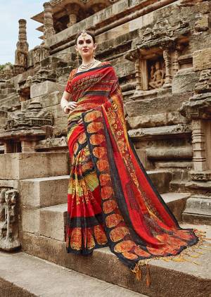 Here Is A Beautiful and Attractive Red Colored Saree Paired With Red Colored Blouse. This Saree And Blouse Are Khadi Silk Based Beautified With Prints. Buy Now.