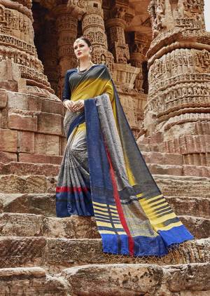 Enhance Your Personality In This Rich Looking Designer Saree With Bold Color Pallete. This Saree Is In Yellow And Grey Paired With Dark Blue Colored Blouse. It Is Fabricated On Khadi Silk Which Is Easy To Carry All Day Long. 