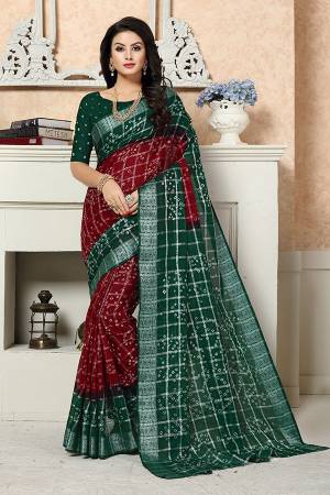 Here Is Designer Saree With Dark Color Pallete In Maroon And Dark Green Color Paired With Dark Green Colored Blouse. This Saree Is Georgette Based Beautified With Bandhani Prints Paired With Art Silk Fabricated Blouse. 