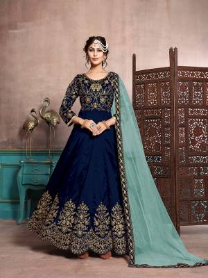Here Is A Beautiful Designer Floor Length Suit In Royal Blue Color Paired With Royal Blue Colored Bottom And Aqua Blue Colored Dupatta. Its Heavy Embroidered Top Is Fabricated On Art Silk Paired With Santoon Bottom And Net Fabricated Dupatta. Its Has Attractive Embroidery Over The Yoke, Panel And Dupatta Lace Border. 