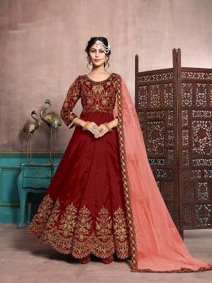 Here Is A Beautiful Designer Floor Length Suit In Red Color Paired With Red Colored Bottom And Peach Colored Dupatta. Its Heavy Embroidered Top Is Fabricated On Art Silk Paired With Santoon Bottom And Net Fabricated Dupatta. Its Has Attractive Embroidery Over The Yoke, Panel And Dupatta Lace Border. 