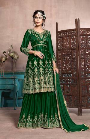 A Must Have Sharara Suit In Every Womens Wardrobe Is Here With This Designer Sharara Suit In Dark Green Color. Its Heavy Embroidered Top Is Fabricated On Satin Georgette Paired With Chiffon Fabricated Dupatta. This Suit Has Fully Stitched Free Size Sharara. Buy Now.