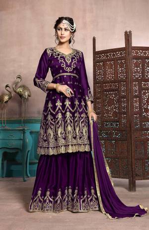 A Must Have Sharara Suit In Every Womens Wardrobe Is Here With This Designer Sharara Suit In Purple Color. Its Heavy Embroidered Top Is Fabricated On Satin Georgette Paired With Chiffon Fabricated Dupatta. This Suit Has Fully Stitched Free Size Sharara. Buy Now.