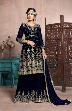 A Must Have Sharara Suit In Every Womens Wardrobe Is Here With This Designer Sharara Suit In Navy Blue Color. Its Heavy Embroidered Top Is Fabricated On Satin Georgette Paired With Chiffon Fabricated Dupatta. This Suit Has Fully Stitched Free Size Sharara. Buy Now.