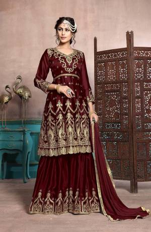 A Must Have Sharara Suit In Every Womens Wardrobe Is Here With This Designer Sharara Suit In Maroon Color. Its Heavy Embroidered Top Is Fabricated On Satin Georgette Paired With Chiffon Fabricated Dupatta. This Suit Has Fully Stitched Free Size Sharara. Buy Now.