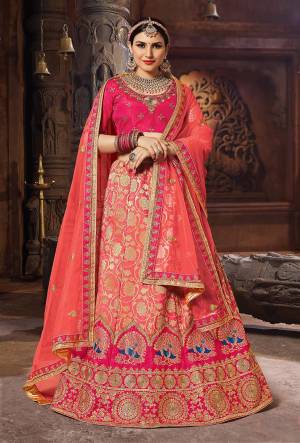 Catch All The Limelight Wearing This Heavy Designer Lehenga Choli In Dark Pink Colored Blouse Paired With Dark Peach Lehenga And Dupatta. Its Blouse Is Fabricated On Art Silk Paired With Banarasi Art Silk Lehenga And Net Fabricated Dupatta. Its Attractive Color And Rich Fabric Will Give An Amazing Look.