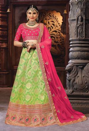 Bright And Appealing Color Is Here With This Designer Lehenga Choli In Fuschia Pink Colored Blouse And Dupatta Paired With Green Colored Lehenga. This Silk Based Lehenga Choli IS Paired With Net Fabricated Dupatta. Buy Now.