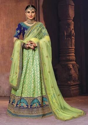 Get Ready For The Upcoming Wedding Season With This Heavy Designer Lehenga Choli In Royal Blue Colored Blouse Paired With Light Green Colored Lehenga And Dupatta. This Lehenga Choli Is Rich Silk Based Paired With Net Fabricated Dupatta. Buy Now.