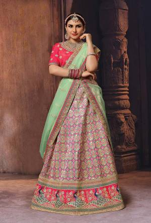 Bright And Appealing Color Is Here With This Designer Lehenga Choli In Fuschia Pink Colored Blouse Paired With Multi Colored Lehenga And Light Green Colored Dupatta.  This Silk Based Lehenga Choli IS Paired With Net Fabricated Dupatta. Buy Now.