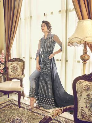 Get Ready For The Upcoming Festive And Wedding Season With This Designer Sharara Suit In Grey Color. This Suit Is Net Based Beautified With Heavy Embroidery All Over It. Buy Now.