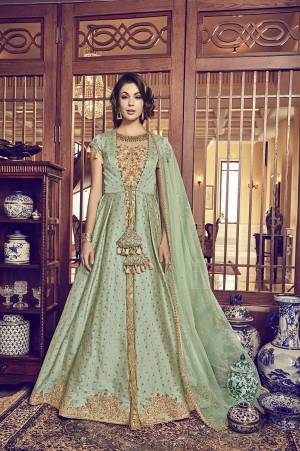 Grab This Heavy Designer Indo-Western Suit In Light Green Colored Jacket With A Pretty Beige Colored Gown Paired With Light Green Colored Bottom And Dupatta. This Beautiful Suit's Gown IS Net Based Paired With Jacquard Silk Fabricated Jacket And Net Dupatta.